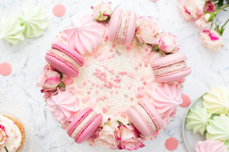 Cake finished with pink macarons and roses